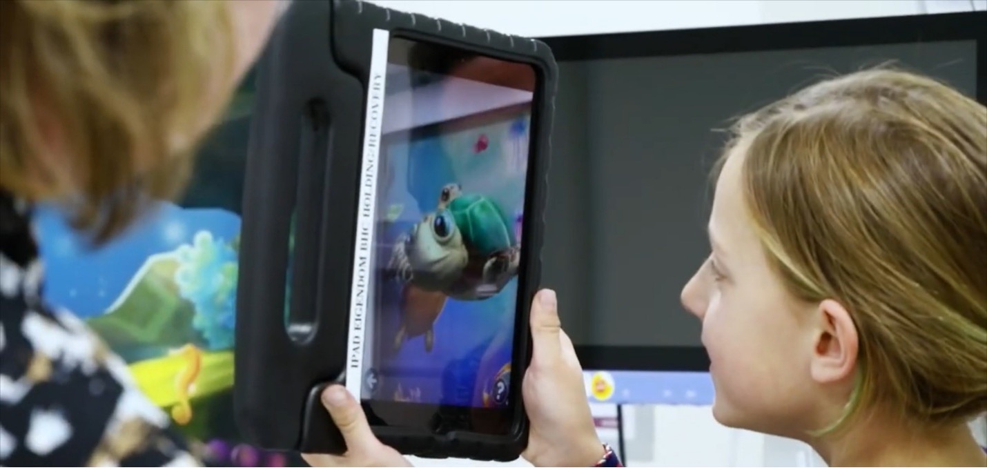 A child using a tablet in a pediatric environment.