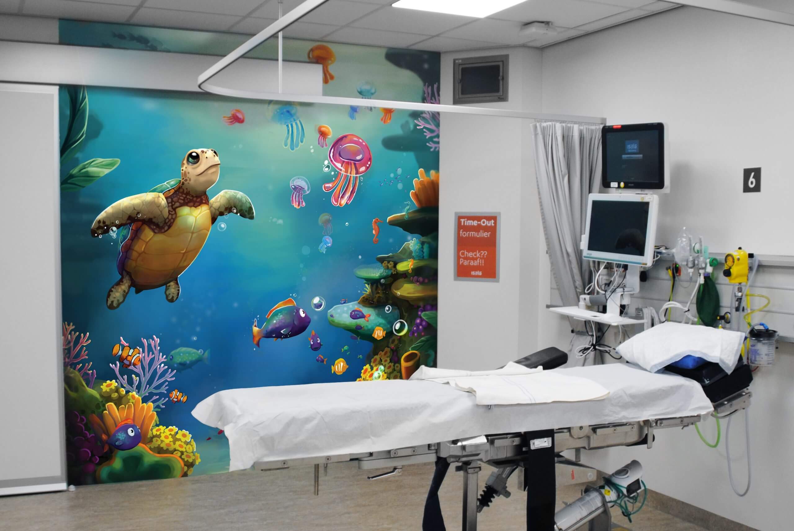 A hospital room transformed with a vibrant underwater StoryWall.